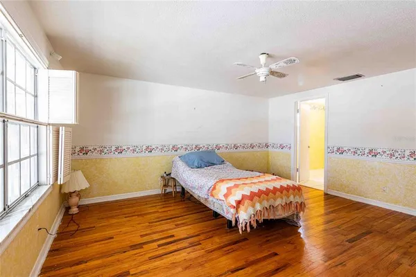 a bedroom with bed and window