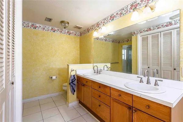 a spacious bathroom with a double vanity sink mirror and