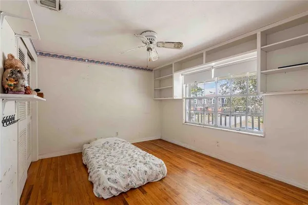 a bedroom with a bed and a window
