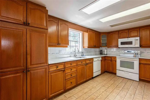 a kitchen with stainless steel appliances granite countertop a refrigerator sink and cabinets