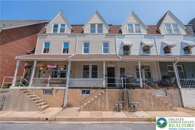 a view of a white house with large windows