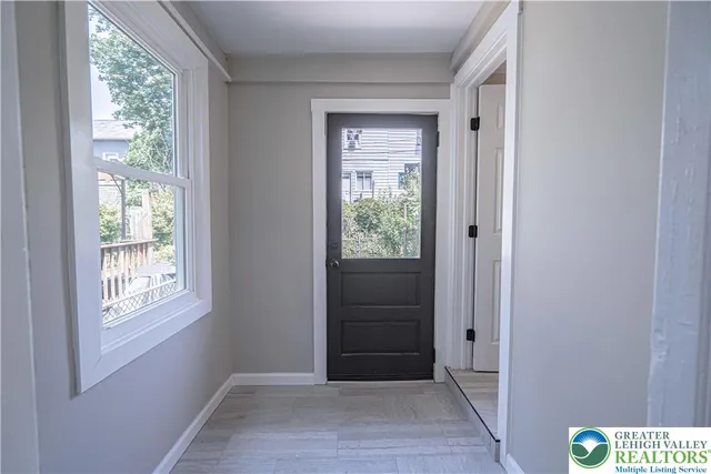 a view of an entryway with wooden floor and closet