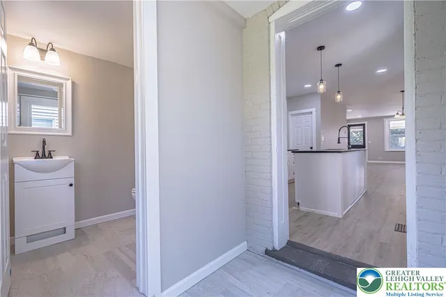a bathroom with a sink a mirror and shower