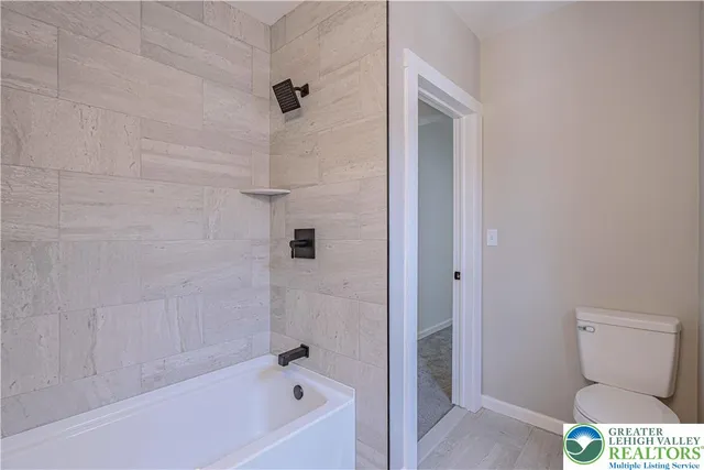 a bathroom with a toilet and a bathtub