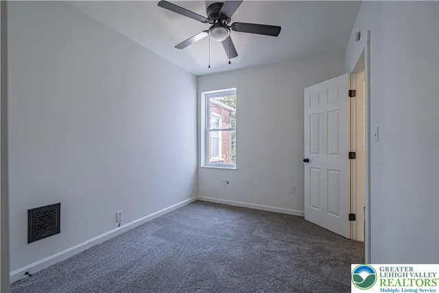 a view of an empty room with a window