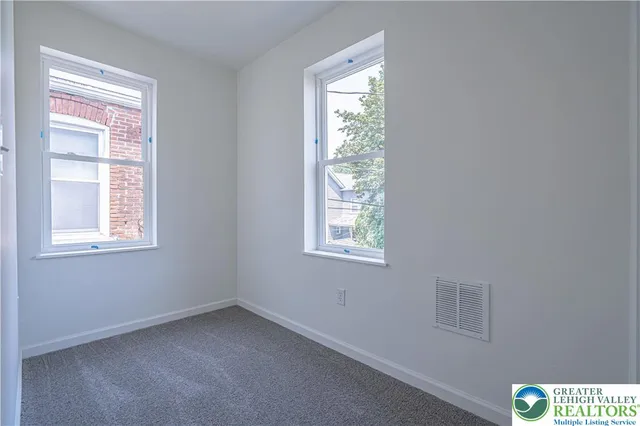 a view of an empty room with a window