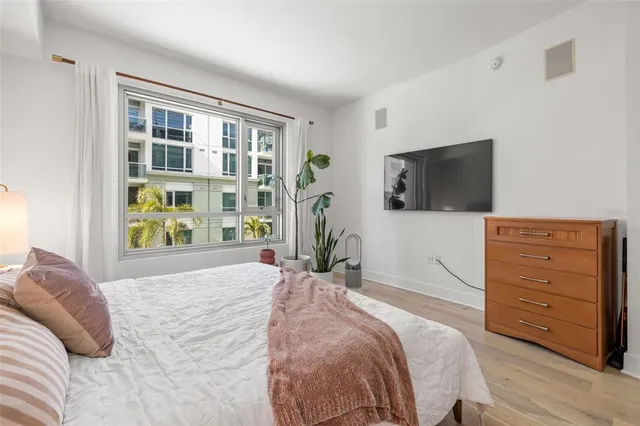 a bedroom with a bed and a flat tv screen
