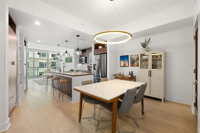 a large kitchen with a table and chairs
