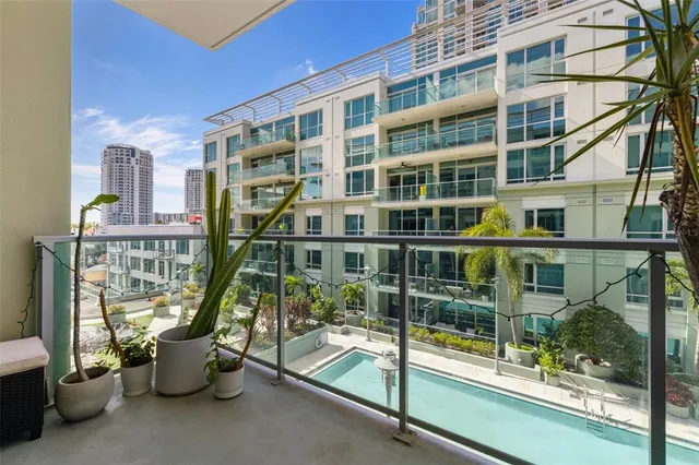 a view of roof deck with chair and glass windows