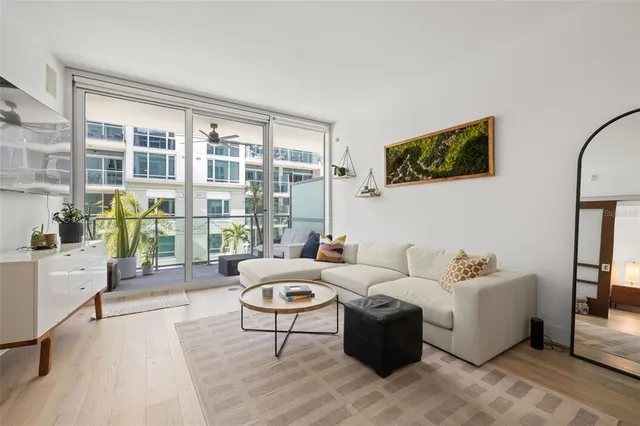 a living room with furniture and a floor to ceiling window