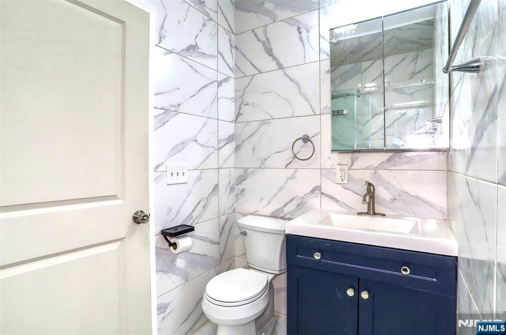 9017 Riverside Place North Bergen, NJ 07047 - Photo 12 of 27 a bathroom with a sink toilet vanity and shower