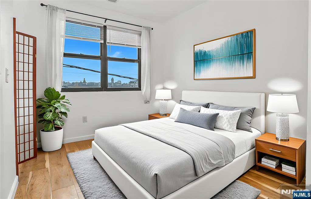 9017 Riverside Place North Bergen, NJ 07047 - Photo 16 of 27 a bedroom with a bed and a painting on the wall