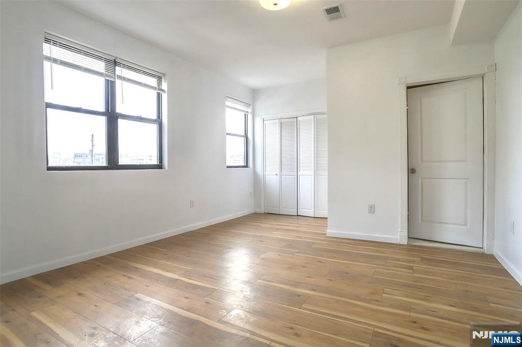 9017 Riverside Place North Bergen, NJ 07047 - Photo 19 of 27 a view of an empty room with wooden floor and a window
