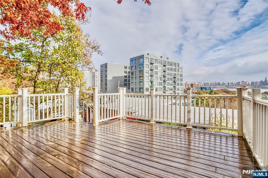 9017 Riverside Place North Bergen, NJ 07047 - Photo 21 of 27 an empty room with wooden floor and fence and city view