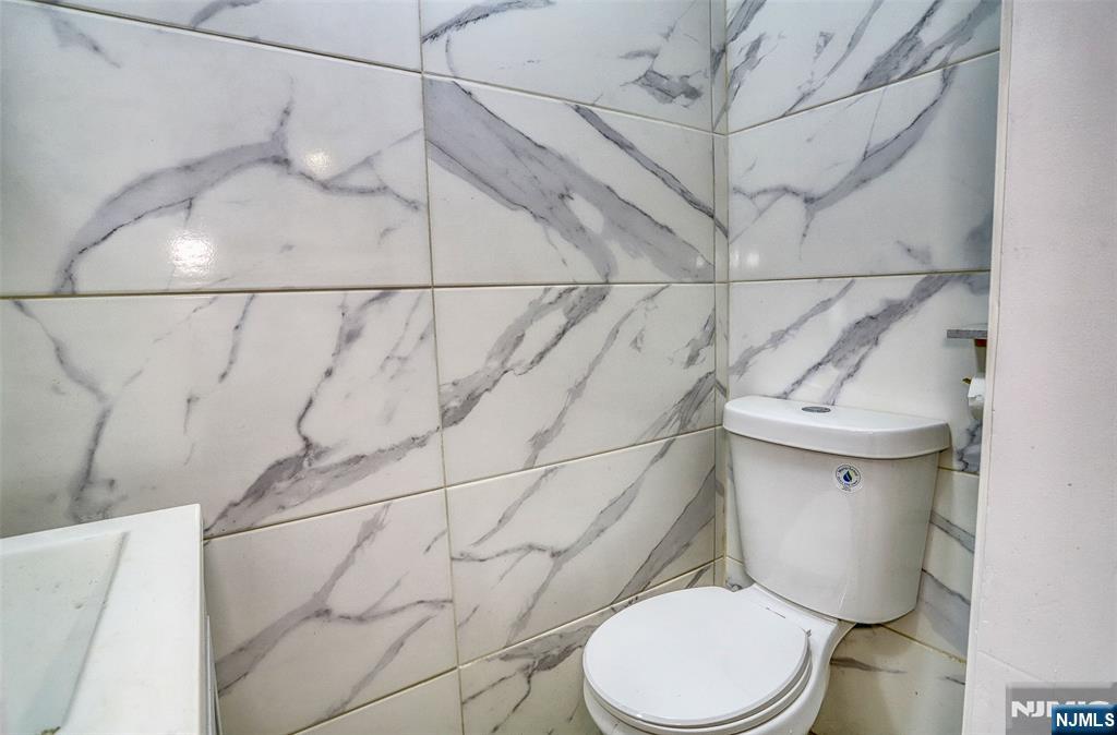 9017 Riverside Place North Bergen, NJ 07047 - Photo 7 of 27 a white toilet sitting next to a white wall