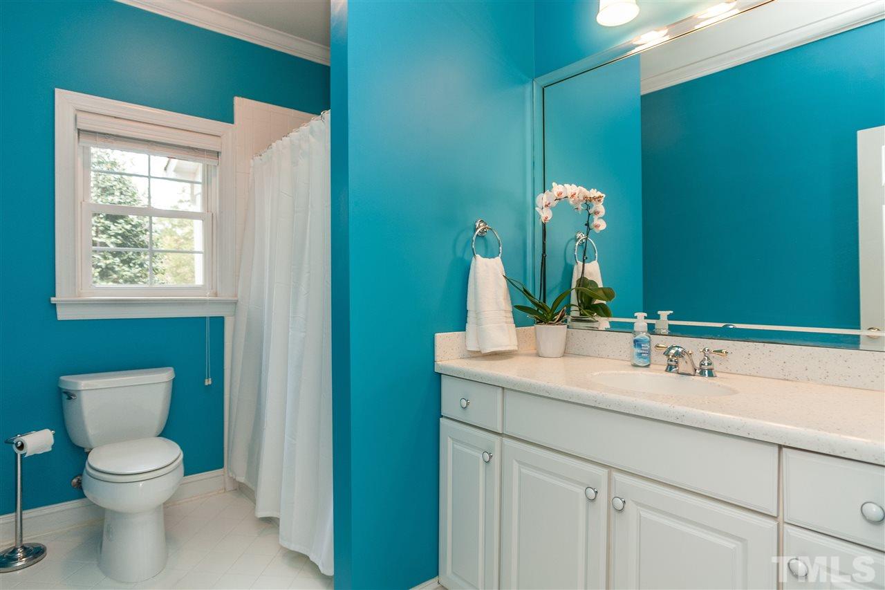6428 Brandywine Road Raleigh, NC 27607 - Photo 14 of 25 a bathroom with a toilet sink and mirror