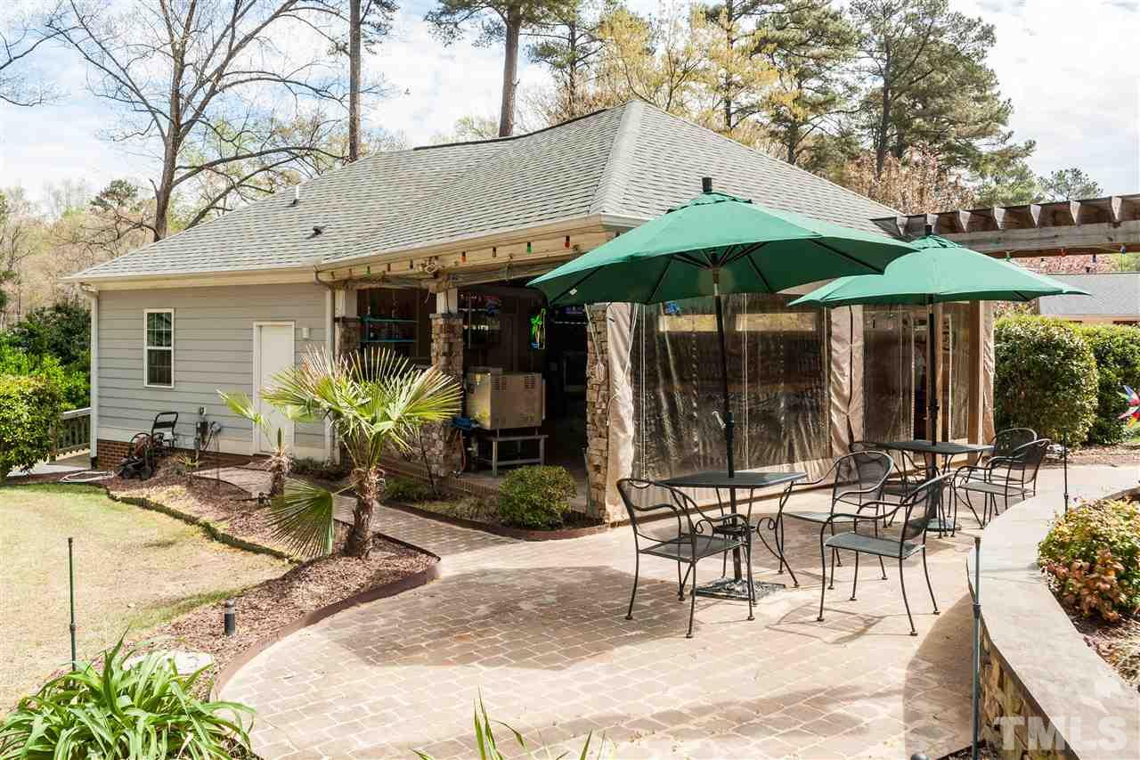 6428 Brandywine Road Raleigh, NC 27607 - Photo 3 of 25 a patio with a table and chairs under an umbrella