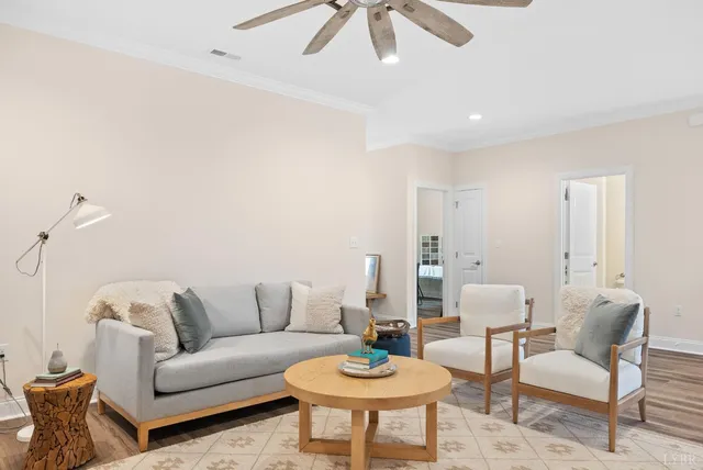 a living room with furniture and a wooden floor