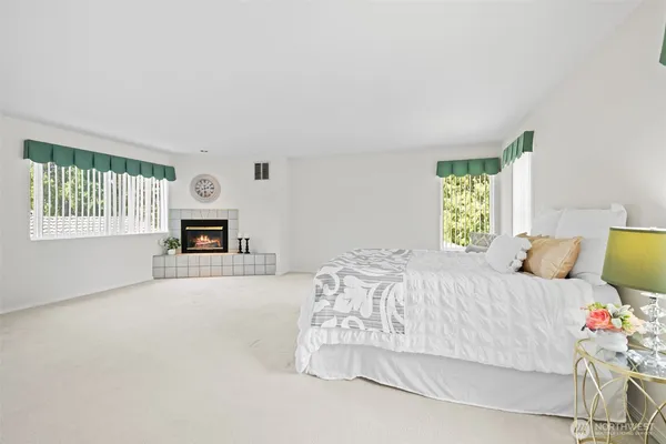 a bedroom with a bed couch and window