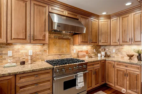 a kitchen with stainless steel appliances granite countertop a stove and a sink