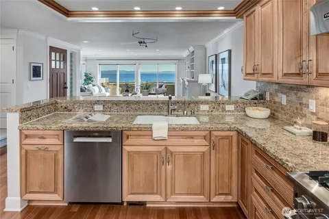 a kitchen with stainless steel appliances granite countertop a sink and cabinets