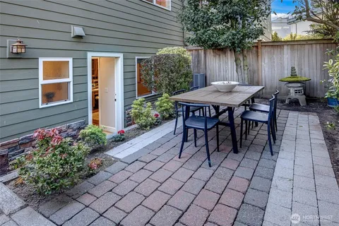 a backyard of a house with yard and outdoor seating