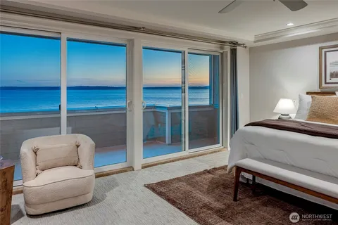 a large bedroom with a bed and a chandelier