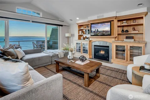 a living room with furniture kitchen view and a potted plant