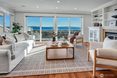 a living room with furniture fireplace and a table