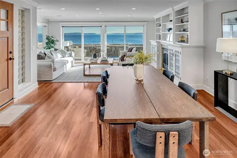 a living room with furniture a flat screen tv and a floor to ceiling window