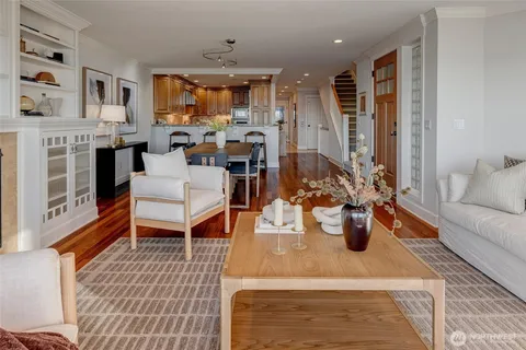 a living room with fireplace furniture and a rug
