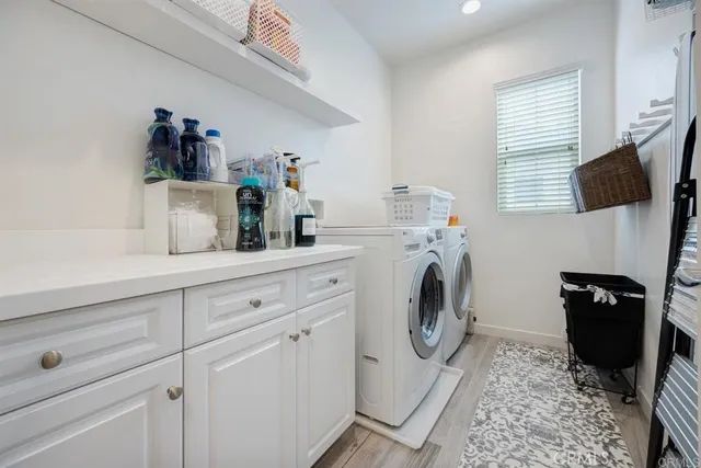 a utility room with sink dryer and washer