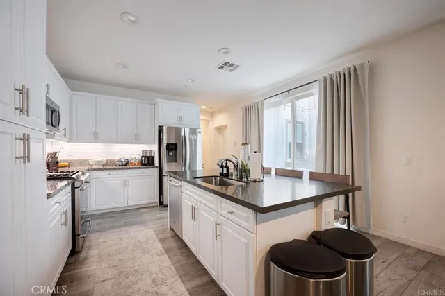 a kitchen with a stove a sink and a refrigerator