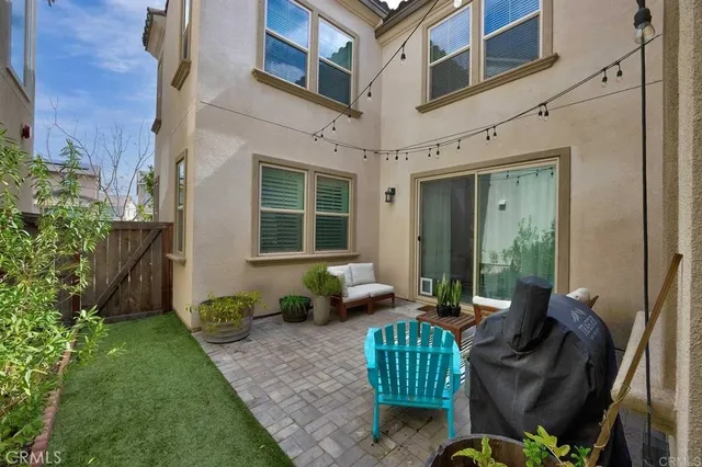 a view of a patio with couches chairs and a potted plant