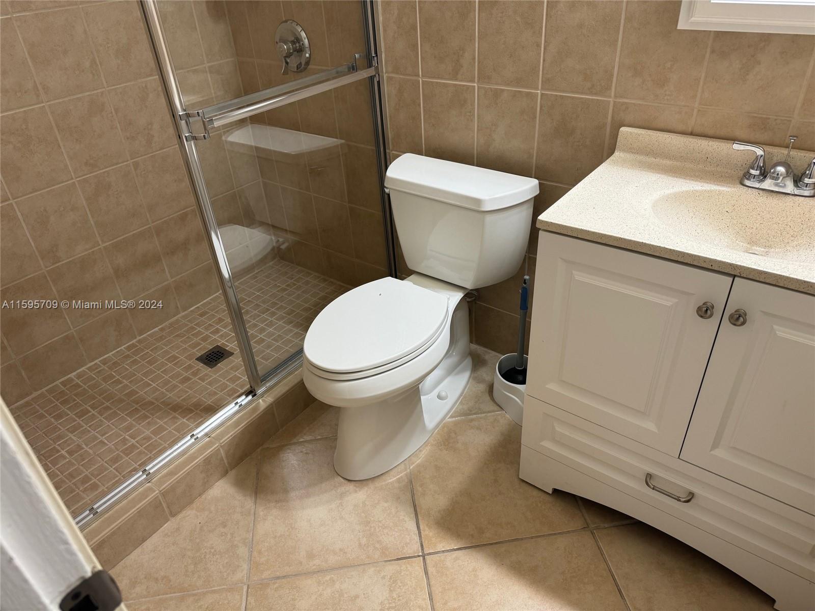 2029 Pierce Street, Unit 3 Hollywood, FL 33020 - Photo 7 of 8 a bathroom with a toilet and a sink