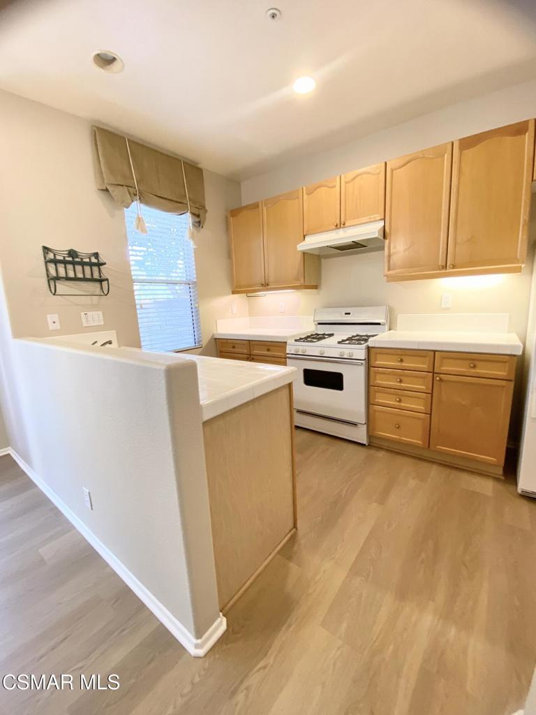 273 Springmist Lane Simi Valley, CA 93065 - Photo 7 of 14 a kitchen with granite countertop a stove top oven sink and cabinets