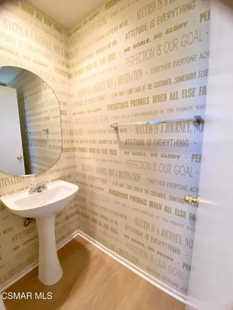 a bathroom with a sink a toilet and mirror