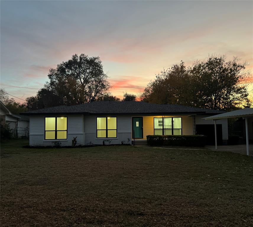 a front view of house with yard and trees