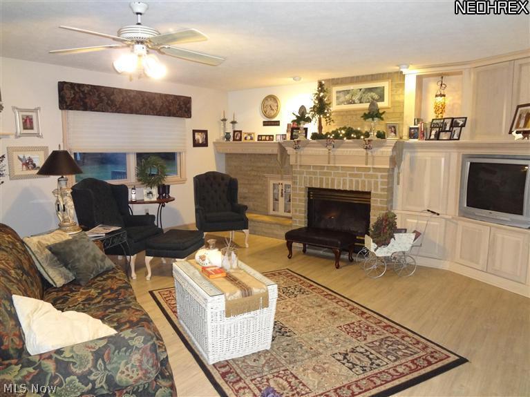 3306 Fox Road Sandusky, OH 44870 - Photo 6 of 25 Large living room with wood flooring, bricked gas fireplace, lots of built in storage.
