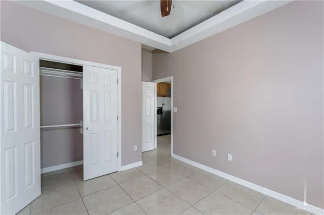 a view of a hallway with closet and cabinet