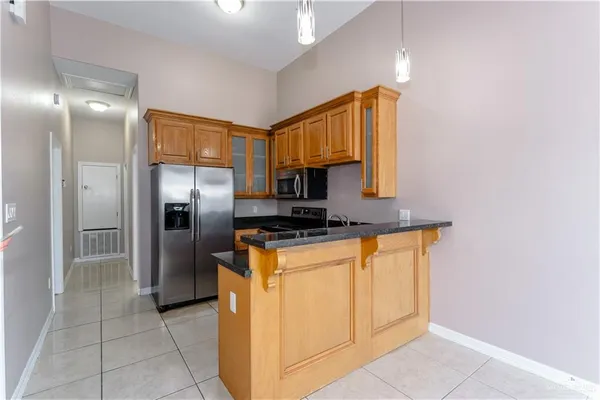 a kitchen with stainless steel appliances a refrigerator and a stove