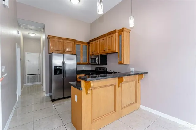 a kitchen with stainless steel appliances a refrigerator and a stove