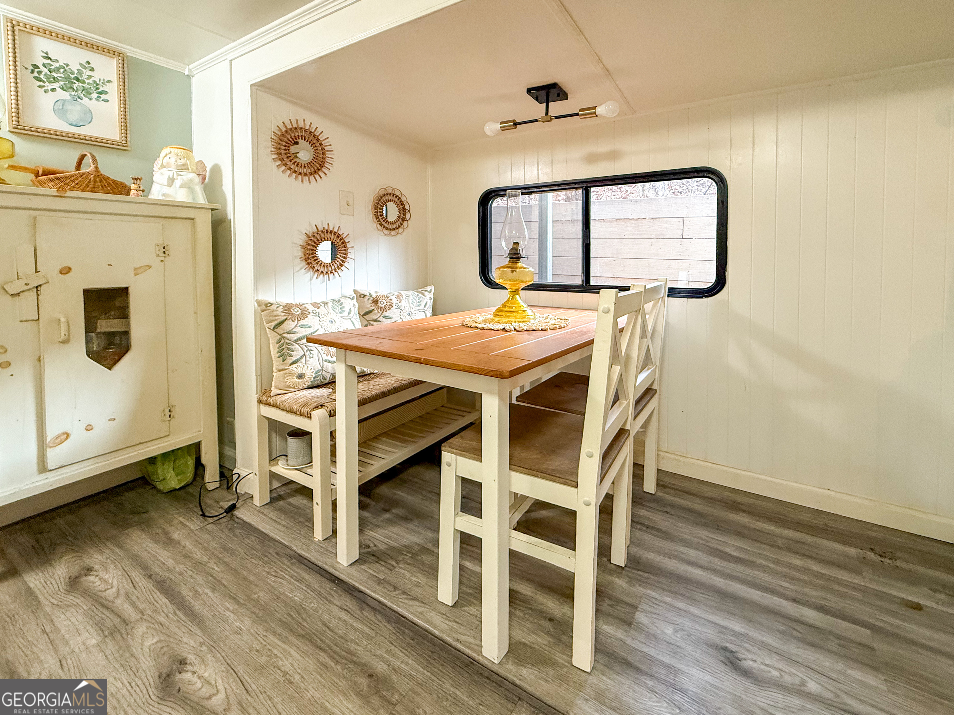 227 Canyon Pass Cleveland, GA 30528 - Photo 11 of 15 a dining room with wooden floor a glass table and chairs