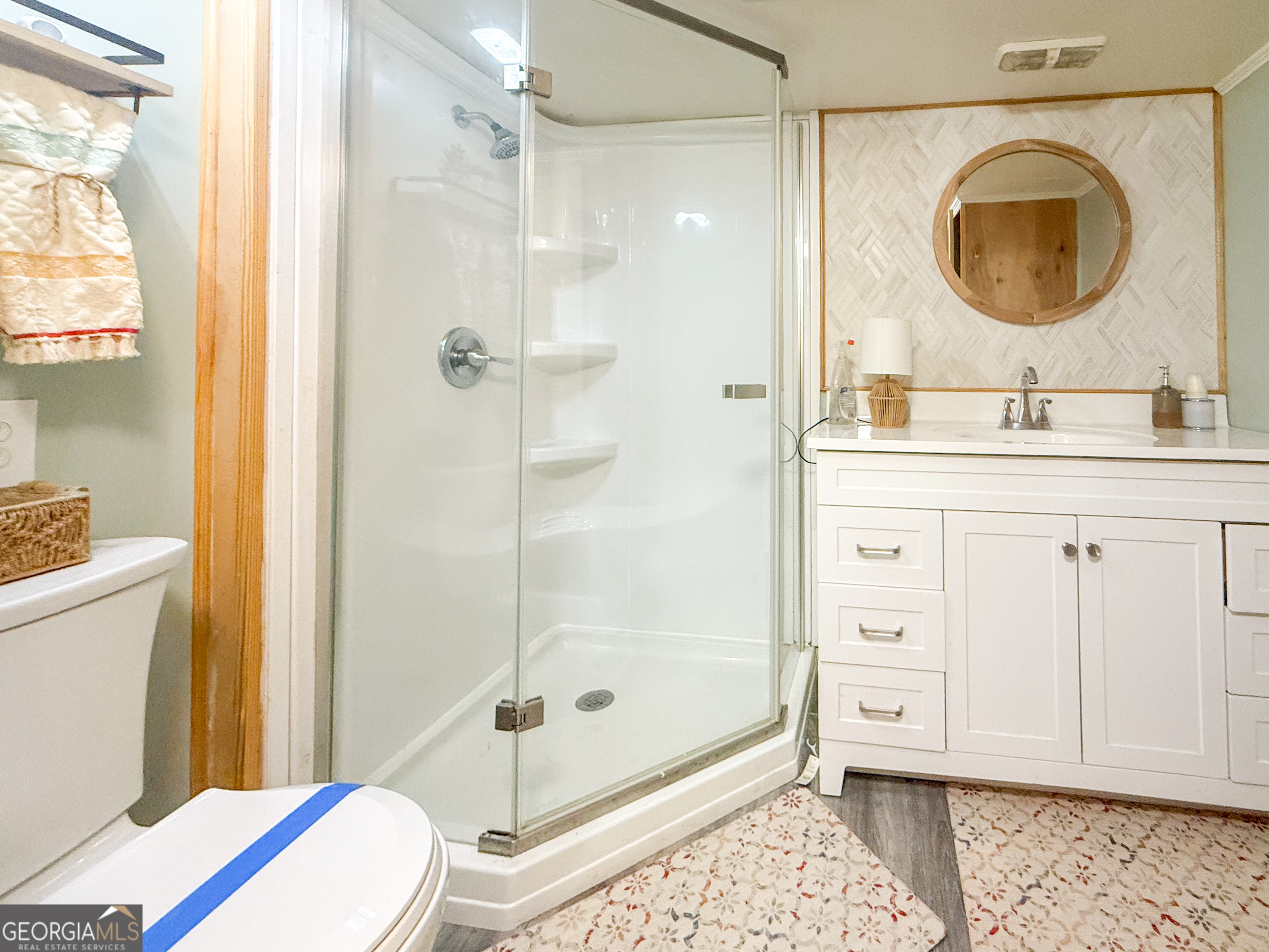 227 Canyon Pass Cleveland, GA 30528 - Photo 12 of 15 a bathroom with a granite countertop sink toilet mirror and shower