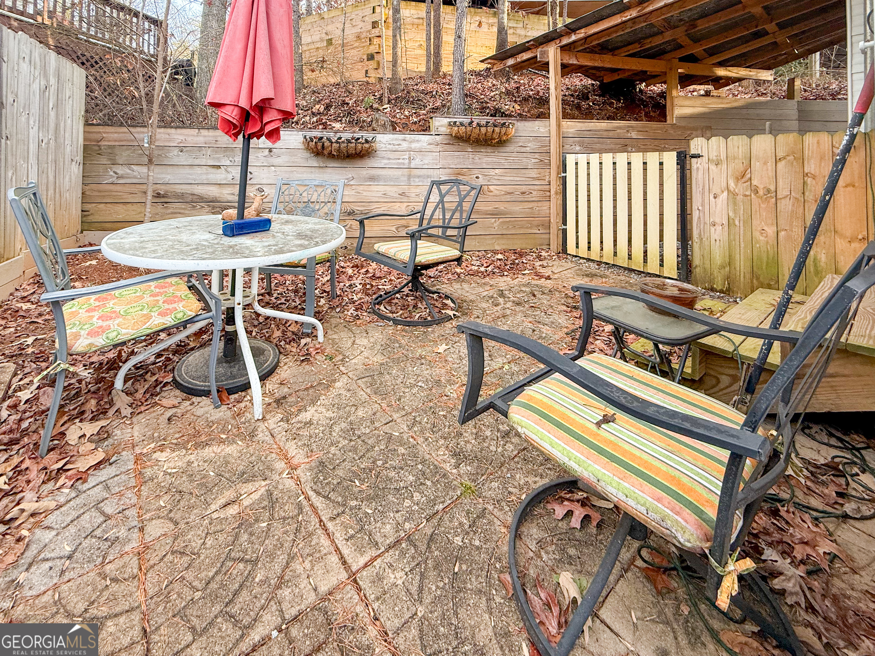 227 Canyon Pass Cleveland, GA 30528 - Photo 14 of 15 a view of a patio with a table and chairs