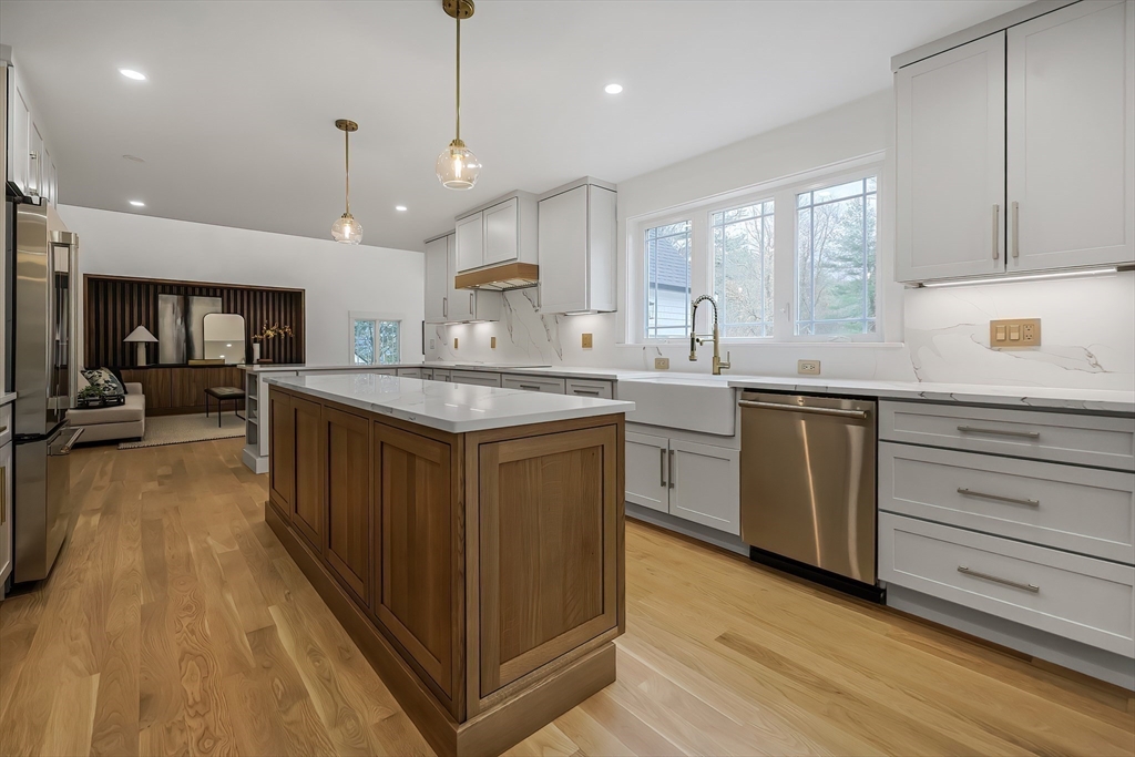 54 Spywood Road Sherborn, MA 01770 - Photo 11 of 41 a kitchen with a sink a counter top space stainless steel appliances and cabinets