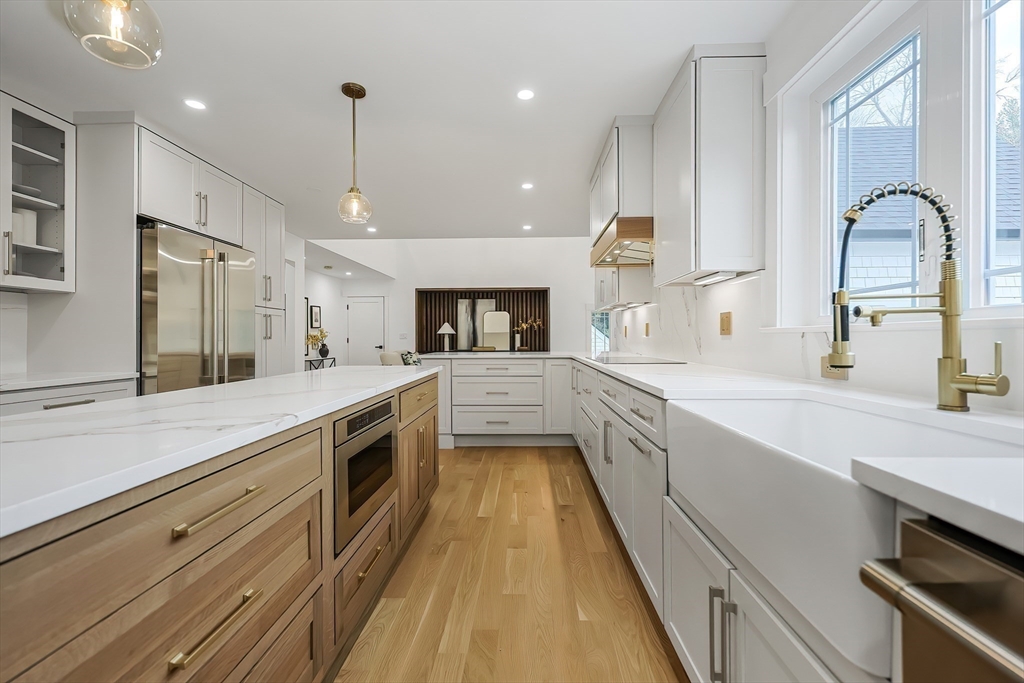 54 Spywood Road Sherborn, MA 01770 - Photo 12 of 41 a large kitchen with a large counter top a sink stainless steel appliances and cabinets
