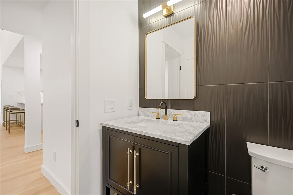 54 Spywood Road Sherborn, MA 01770 - Photo 17 of 41 a bathroom with a sink vanity and a mirror