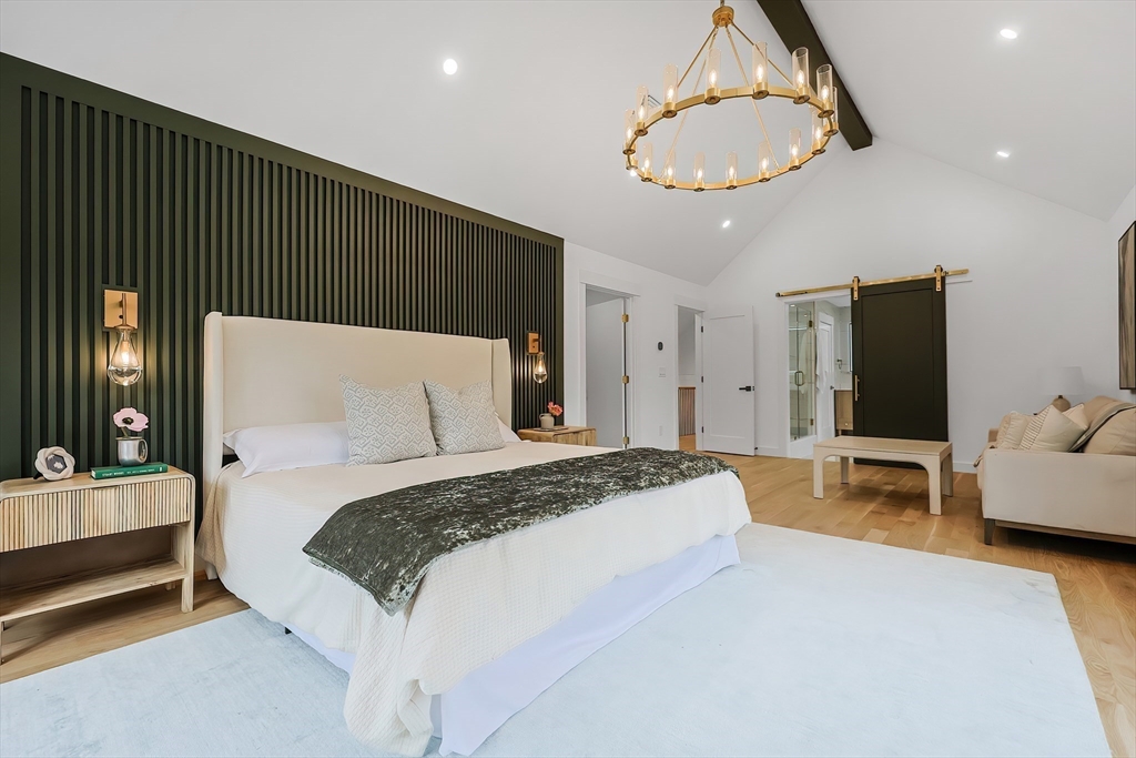 54 Spywood Road Sherborn, MA 01770 - Photo 20 of 41 a bedroom with a bed and a chandelier