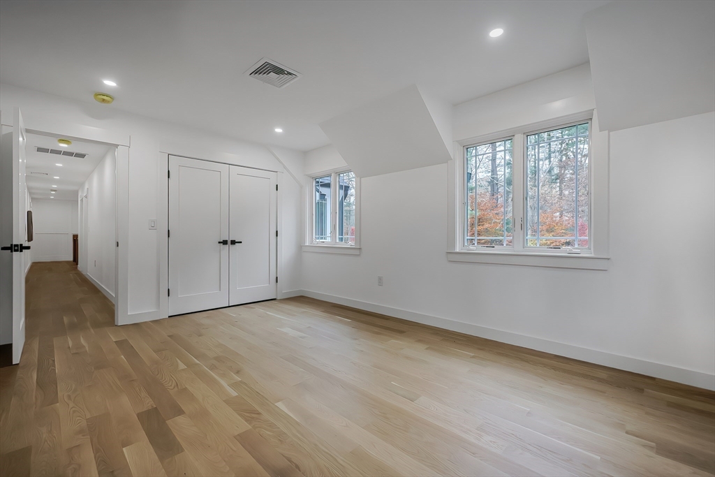 54 Spywood Road Sherborn, MA 01770 - Photo 27 of 41 a view of an empty room with wooden floor and a window